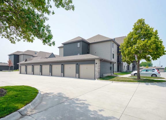 a row of detached garages next to an apartment building