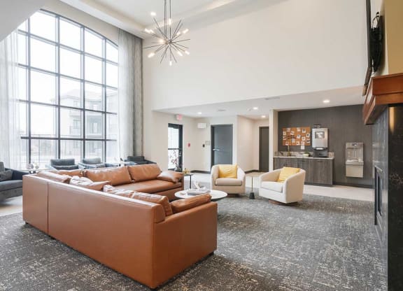 The clubhouse lounge featuring a floor to ceiling window and plenty of seating options