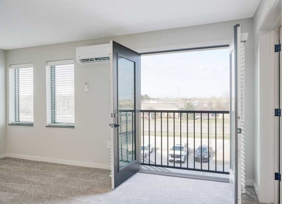 A living room with double doors to a Juliet balcony
