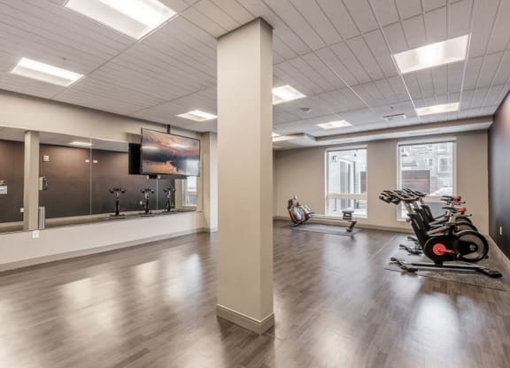 Spin and yoga studio with TV screen for on-demand fitness classes