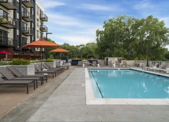 Resort-style pool with beach lounge chairs.