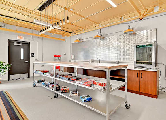 A room with a metal cart and a cabinet.