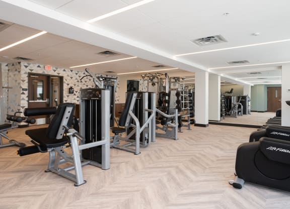 Community gym with a variety of workout and fitness equipment at The Rowan