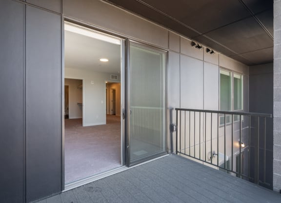 large balcony with sliding screen and glass door