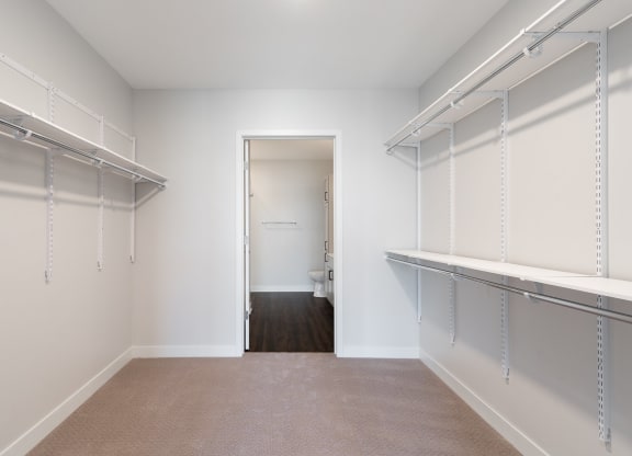 Large walk in closet with ample shelving and hanging space