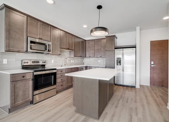 Spacious open kitchen with matching steel appliances and plenty of cabinet storage space at The Rowan in Eagan Minnesota