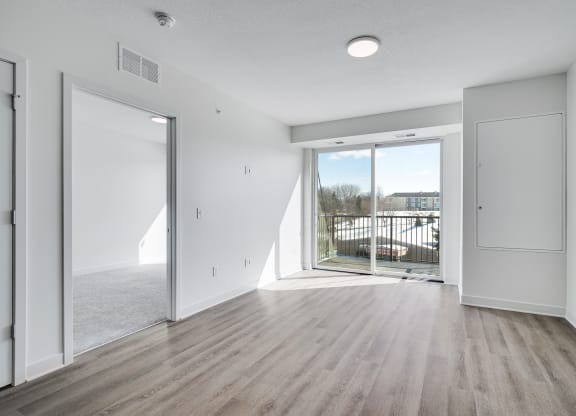 Spacious and bright dining and living area with balcony entry at The Rowan in Eagan Minnesota