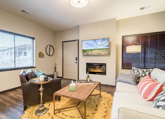 A living room with a fireplace and a painting on the wall.