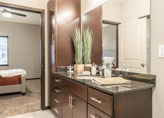 A bathroom with a vanity and a mirror.