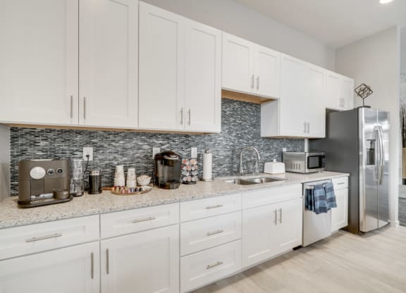 Clubhouse kitchen counter with two different kinds of coffee machines