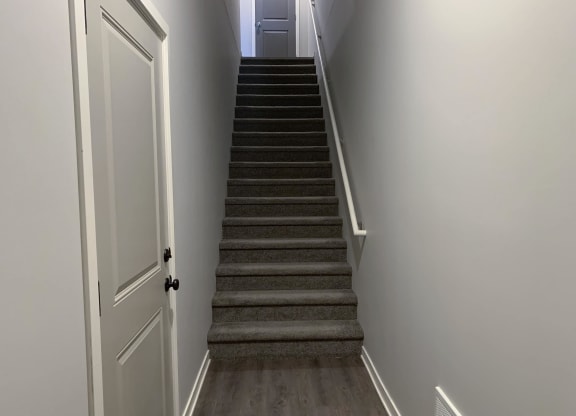 Stairs leading to second story villa at the villas at mahoney park