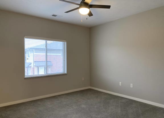 Spacious carpeted bedroom with large window allowing a lot of natural light in at The Villas at Mahoney Park