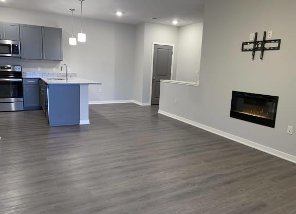 spacious living and dining room with fireplace for extra warmth at the villas at mahoney park