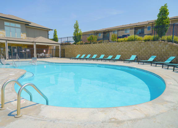 a resort-style pool surrounded by lounge chairs