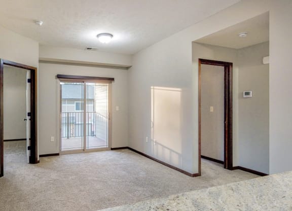 The kitchen overlooks the living area and private balcony at The Villas at Wilderness Ridge in southwest Lincoln NE 68512