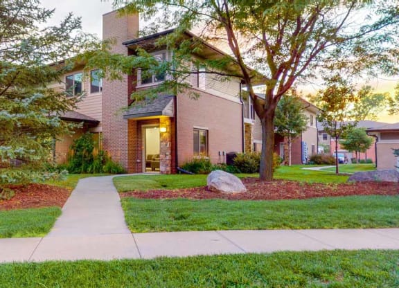 an apartment with a sidewalk in front of it