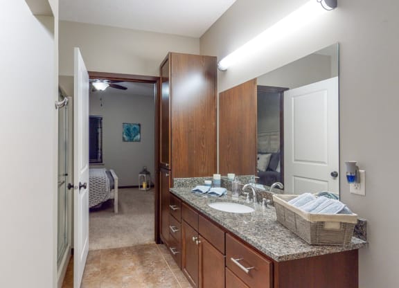 The master bath in the Cedar floor plan features a large vanity, shower, and large linen cabinet.