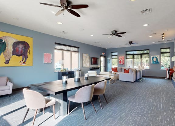 Clubhouse lounge with blue walls and a large yellow painting on the wall