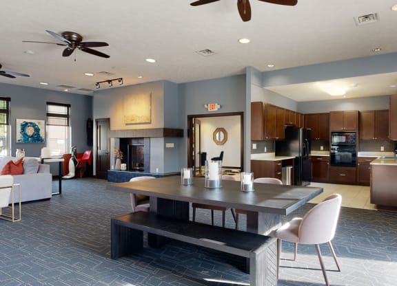 the clubhouse with a table and chairs and a kitchen in the background