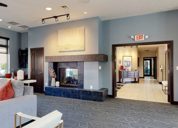 a clubhouse living room with a fireplace and blue walls
