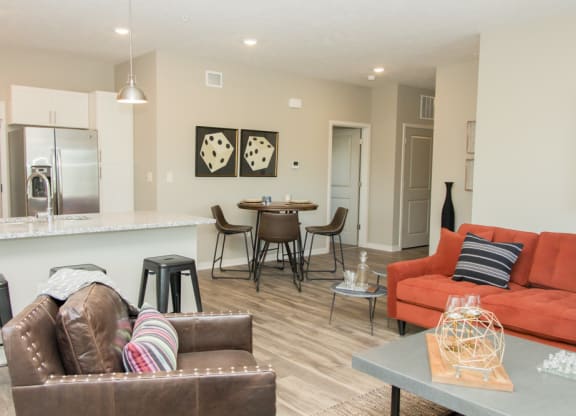 Open layout with living room and kitchen with stainless steel appliances at Villas at Mahoney Park apartments
