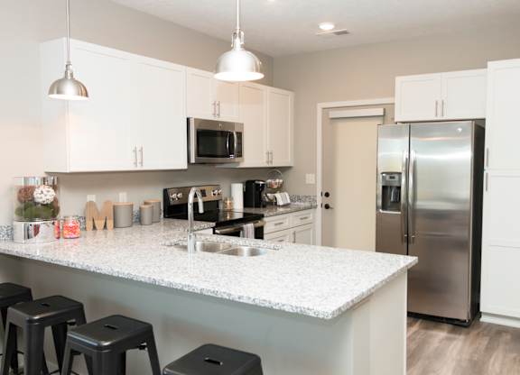 white cabinet kitchen with bar stool seating