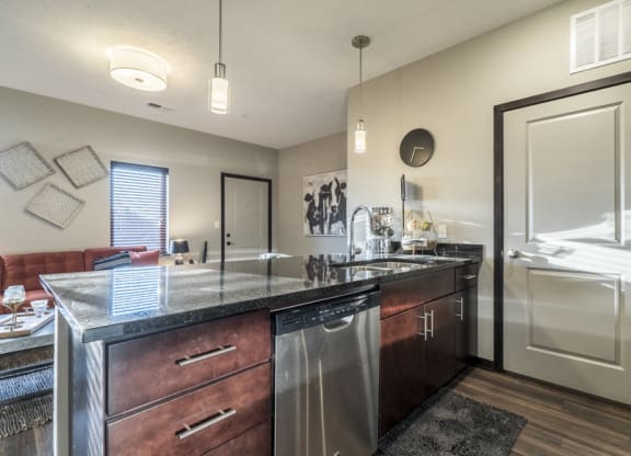 Kitchen with dark cabinets and dark granite counter tops at The Villas at Mahoney Park