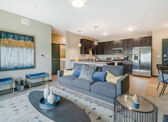 A modern living room with a grey sofa and a coffee table