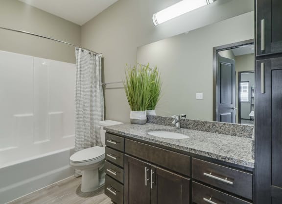 Bathroom with granite countertops at WH Flats new luxury apartments in south Lincoln NE 68516