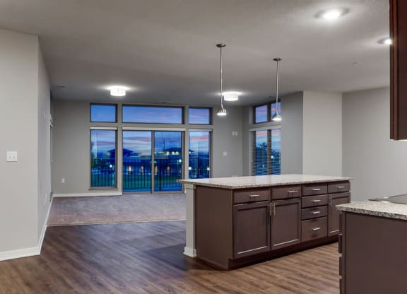 Large living space with floor to ceiling windows providing a great view at WH Flats