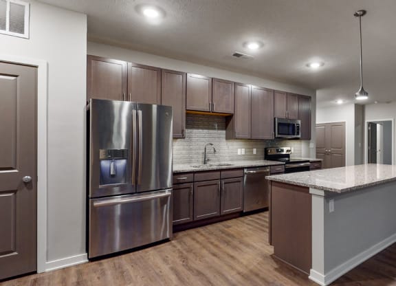 Spacious kitchen with granite countertops and stainless-steel appliances