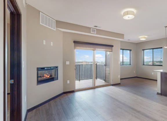 The 2 bedroom Snowdrop with den floor plan at WH Flats features natural light and a spacious dining and living area with electric fireplace.