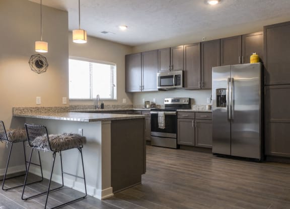 Large kitchen with stainless-steel appliances and peninsula at WH Flats new luxury apartments in south Lincoln NE 68516