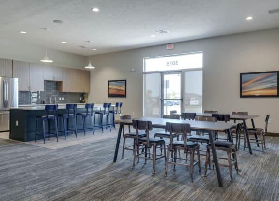 WH Flats luxury apartments clubhouse with kitchen and tables