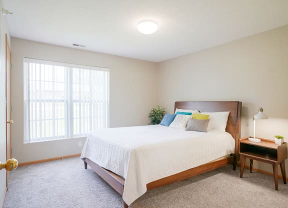 A furnished bedroom with a large bed and a window at Williamsburg Park