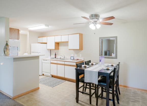 a kitchen and dining room with a table and chairs