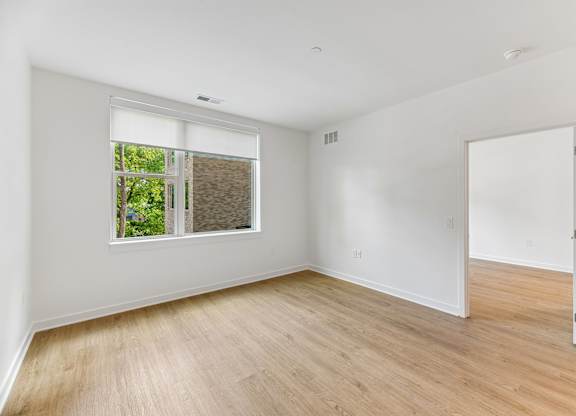 A room with a window and a door.