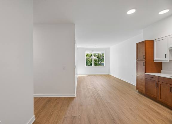 A room with wooden floors and white walls.