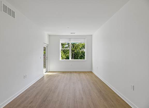 A long hallway with a door at the end.