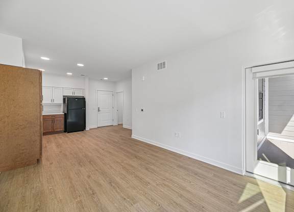 A room with a wooden floor and white walls.