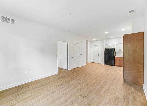 A room with a wooden floor and white walls.