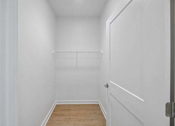 A white hallway with a door on the right.