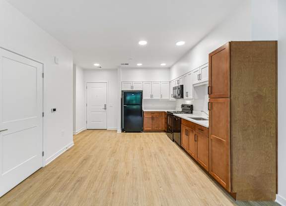 A kitchen with wooden floors and white walls.