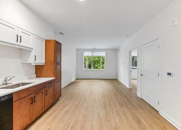 A kitchen with wooden cabinets and a white sink.