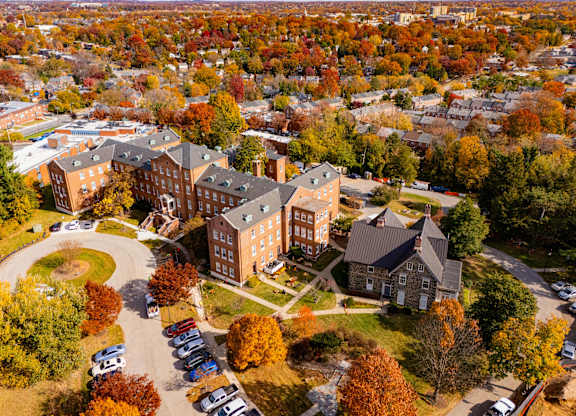 An aerial view of a campus with a large building in the center.