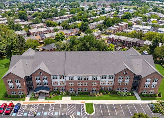 A large brick building with a parking lot in front.