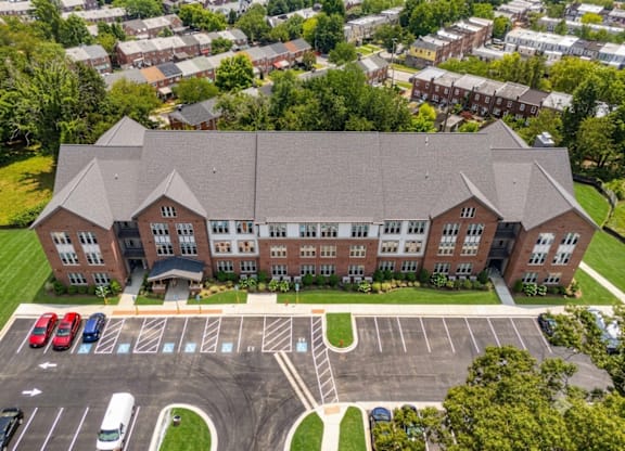 A large building with a parking lot in front of it.