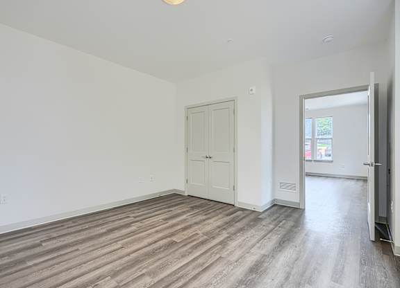 A room with a white door and a window.