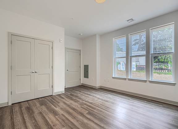 A room with a wooden floor and white walls.