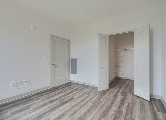 A room with a wooden floor and white walls.